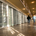 people walking along prison cells New NIH-Department of Justice Study 