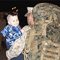 Marine carrying toddler son